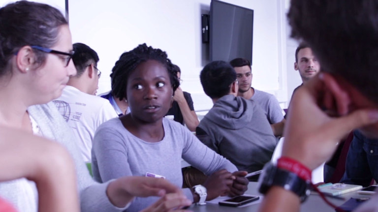 Students having a discussion around a table