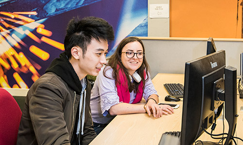 two students sat at a computer